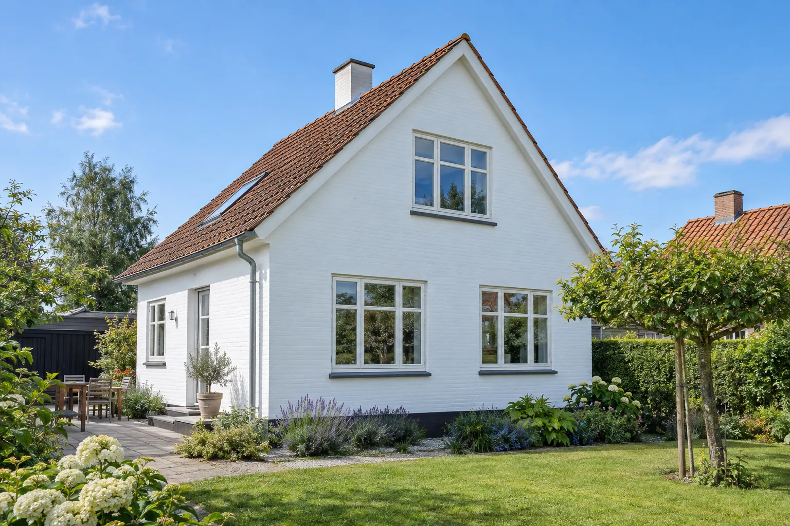 Danish house with freshly painted white rendered facade